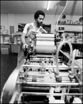 Man Turns Rollers on Printing Equipment, A by Skip Gandy