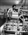 Man Turns Rollers on Printing Equipment, B by Skip Gandy