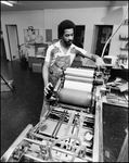 Man Turns Rollers on Printing Equipment, C by Skip Gandy