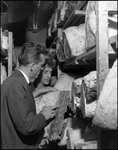 Bern Laxer and Man Examine Beef in Storage at Bern's Steak House by Skip Gandy