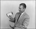 Man Holds Check from the First National Bank of Tampa, A by Skip Gandy