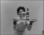 Woman Holds Tray with Tropical Ale and Glass by Skip Gandy