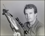 Man Posing with Crossbow Pointed into Air, A by Skip Gandy