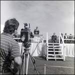 People Being Filmed While Standing on Stage at a Groundbreaking Ceremony, A by Skip Gandy