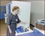 Woman Inspecting Teleprocessing System Mainframe, C by Skip Gandy