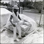 Worker Handling Concrete Bags, B by Skip Gandy