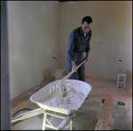 Worker Mixing Concrete by Skip Gandy