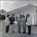 Businessmen in Front of Office Building, A by Skip Gandy