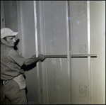 Man Measures Spacing between Steel Studs by George Skip Gandy IV