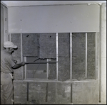 Man Measures Spacing between Steel Studs During Insulation Installation by George Skip Gandy IV