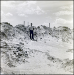 Man Standing Beside Sandy Piles of Dirt, Tampa, Florida, A by George Skip Gandy IV