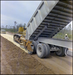 Dump Truck and Spreader Work on Future Road, Tampa, Florida, A by George Skip Gandy IV