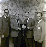 Three Men and John E. Douglas Pose with Agency Development Award, Tampa, Florida, B by George Skip Gandy IV