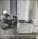 Worker Measuring Concrete Damage, Tampa, Florida, A by George Skip Gandy IV