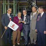 W.M. Neuman, Man, Charles Campbell, Penn Talaferro, and R.S. Hatfield with 20-Billionth Can Flag, Tampa, Florida by George Skip Gandy IV