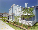 Front Exterior of Blue Two-Story Building, Calibre Bend Apartments by George Skip Gandy IV