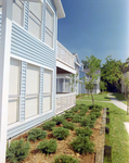 Side Exterior of Blue Two-Story Building, Calibre Bend Apartments by George Skip Gandy IV