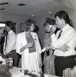 Two Women and a Man in Conversation at a Party by George Skip Gandy IV