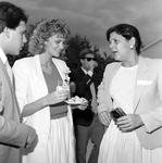 Two Women Chatting with Man in a Suit at a Party by George Skip Gandy IV