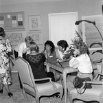 A Group of Women Talking Around a Table at a Party by George Skip Gandy IV