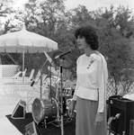 Woman Speaking on Stage at a Party by George Skip Gandy IV