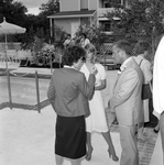 Two Women Talking with a Man at a Party by George Skip Gandy IV