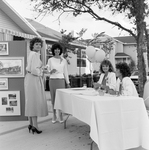 Women Around an Information Table by George Skip Gandy IV