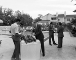 Three Men at Buffet Table by the Pool by George Skip Gandy IV