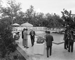 People Gathering by the Pool and Buffet Table by George Skip Gandy IV