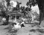 Front View of People Sitting with a Gazebo, C by George Skip Gandy IV