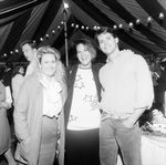 Two Women and a Man Posing for Photo at a Party Under a Big Top Tent by George Skip Gandy IV