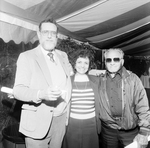 Two Men and a Woman Posing for Photo at a Party by George Skip Gandy IV