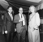 Two Men and a Woman Smiling for a Photo at a Party by George Skip Gandy IV