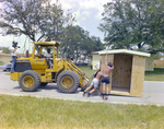 Workers Offloading a Shed From a Bulldozer, Carlton, Fields, Ward, A by George Skip Gandy IV