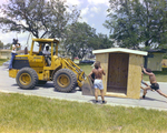 Workers Offloading a Shed From a Bulldozer, Carlton, Fields, Ward, B by George Skip Gandy IV