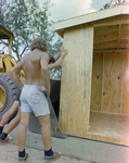 Back of Worker Inspecting a Wooden Shed by George Skip Gandy IV