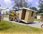 Bulldozer Holding a Wooden Shed A by George Skip Gandy IV