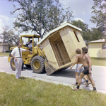 Man Pointing to Bulldozer Holding a Shed by George Skip Gandy IV