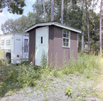 Brown Wooden Shed Next to a House Trailer B by George Skip Gandy IV