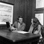 Robert J. Staumbaugh and Cindy Hallgren at a Desk at O.H. Carter Co. Inc., A by George Skip Gandy IV