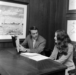 Robert J. Staumbaugh and Cindy Hallgren at a Desk at O.H. Carter Co. Inc., B by George Skip Gandy IV