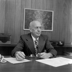 David Beebe Sitting at Desk at O.H. Carter Co. Inc., A by George Skip Gandy IV