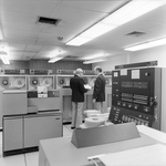 Calvin Carter Standing with Employee in Computer Room, C by George Skip Gandy IV