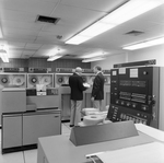 Calvin Carter Standing with Employee in Computer Room, D by George Skip Gandy IV