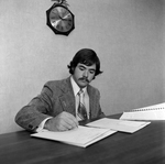 Male Employee Writing at Desk at O.H. Carter Co. , A by George Skip Gandy IV