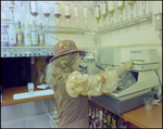 Woman Tending Bar and Operating Cash Register, I by Skip Gandy