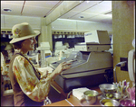 Woman Operating Cash Register, B by Skip Gandy