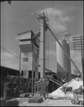 Workers Operating Machinery at Factory by Skip Gandy