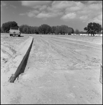 Unpaved Road in Subdivision Showing Curb and Parked Car, B by Skip Gandy