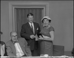 Man and Woman Shake Hands at Florence Champlin Advertising Award Luncheon by Skip Gandy